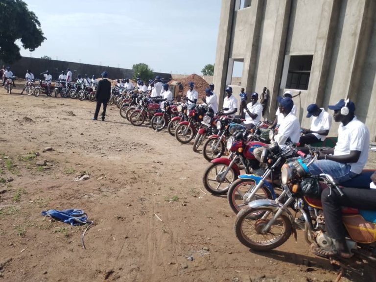 Riders assemble outside the venue in Kuajok