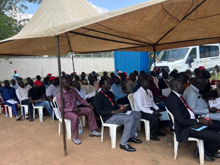 Participants listen to the address in Torit
