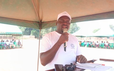Addressing the gathering from the lectern