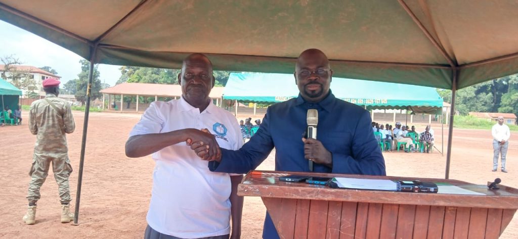 Officials shake hands at the launch of the campaign in Yambio