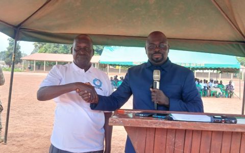 Officials shake hands at the launch of the campaign in Yambio