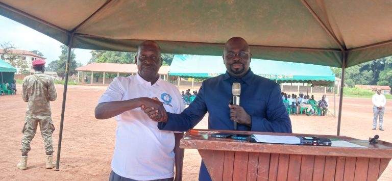 Officials shake hands at the launch of the campaign in Yambio