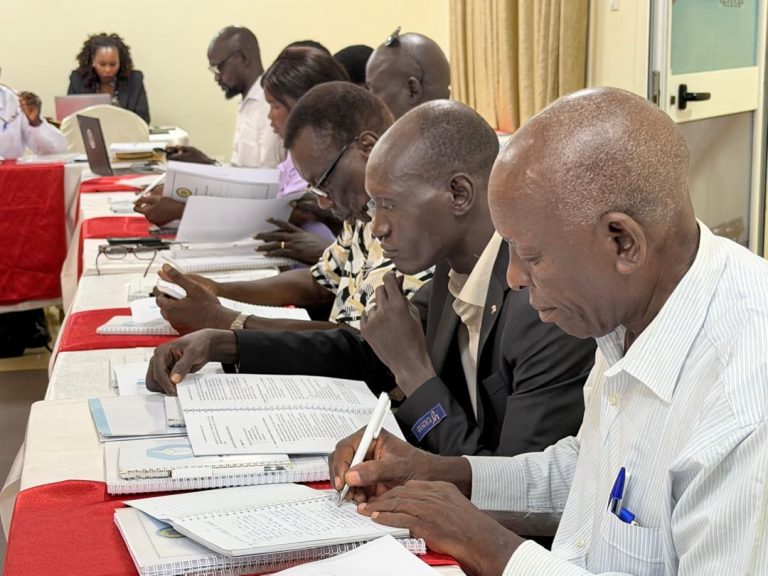 Electoral officials take notes during the session