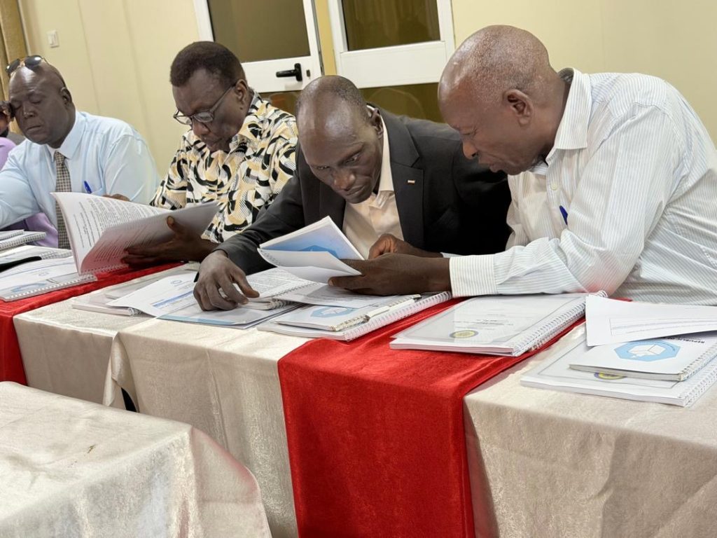 Participants study the training materials in Juba