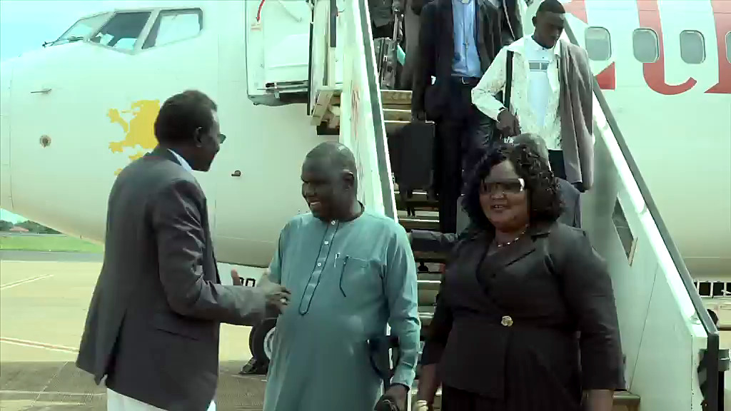 NEC Chairperson Hon. Gabriel Bol Deng is welcomed at the foot of the aircraft steps on his arrival at Juba International Airport from South Africa