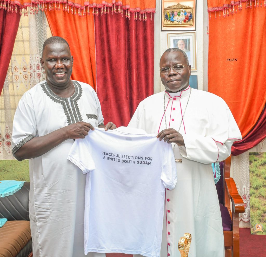 Hon. Gabriel Bol Deng and His Eminence Cardinal Stephen Ameyu Martin Mulla with a civic and voter education T-shirt in Juba